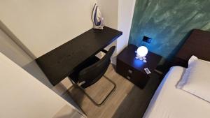 a bedroom with a desk and a chair next to a bed at UnionBNB Apartments in Tirana