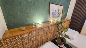 a bedroom with a wooden shelf with a plant on it at UnionBNB Apartments in Tirana