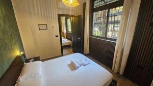 a bedroom with a white bed and a window at UnionBNB Apartments in Tirana