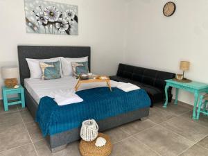 a bedroom with a bed and a couch and a table at Yaya house in Skala Sotiros