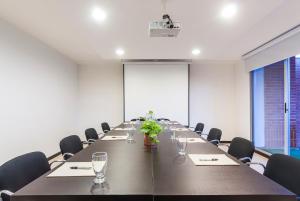 a large conference room with a long table and chairs at Travelers Orange Suites in Medellín
