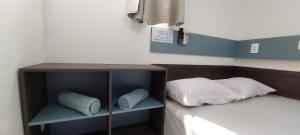 a room with a bed with pillows on it at Casa temporada Araçoiaba in Araçoiaba