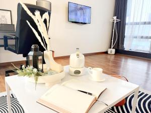a white desk with a computer and a book at The Latrobe - Bangsar Trade Centre in Kuala Lumpur