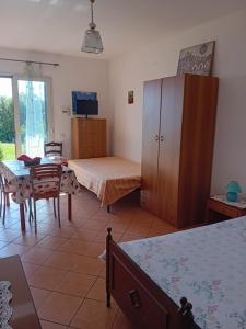 a bedroom with a bed and a desk and a table at Casa paradisoTaorminaEtna in Piedimonte Etneo