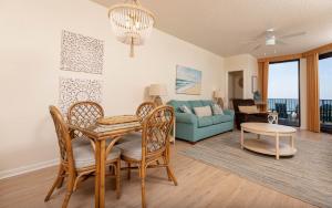 a living room with a table and a couch at Phoenix X 212 condo in Orange Beach
