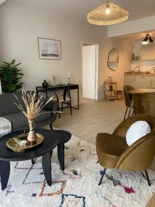 a living room with a couch and chairs and a table at Montana Bussy Saint Georges in Bussy-Saint-Georges +11 photos