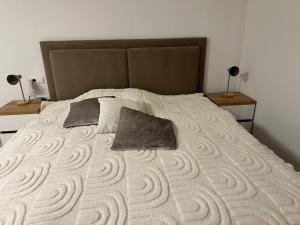 a bedroom with a bed with two pillows on it at Elara in Burgrieden