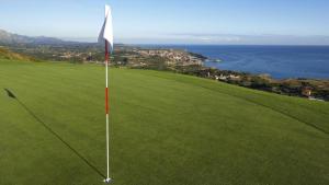 a golf course with a flag on the green at La Posada del Rey in Llanes