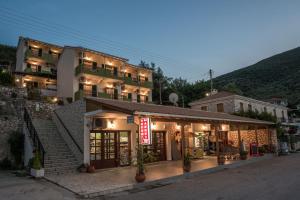 a building with a sign in front of it at Sivota Bay in Sivota
