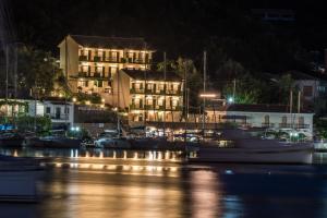 a harbor at night with boats in the water at Sivota Bay in Sivota
