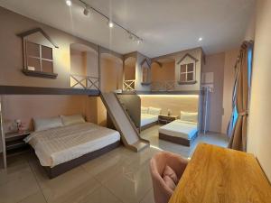 a large room with two beds and a table at jia Residence 21 pax Karaoke & Snooker in Ipoh