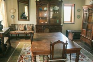 a dining room with a table and a china cabinet at Casa da Tia Augusta in Castro Daire
