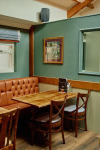 a dining room with a wooden table and chairs at The Pennine Inn in Kirkby Stephen