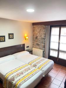 a bedroom with a large bed in a room at La Posada del Rey in Llanes