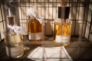 a shelf with three bottles of oils on a table at So&Leo Guest House in Genoa