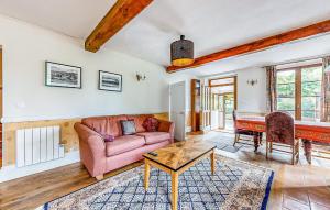 a living room with a couch and a table at Apt A in Jaulgonne
