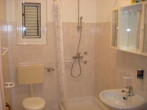 a bathroom with a shower and a toilet and a sink at Villa Jasmin in Bol