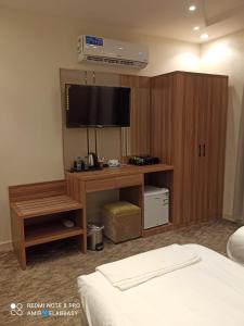 Postel nebo postele na pokoji v ubytování Buyot Malath Serviced Apartment - شقق بيوت ملاذ للشقق المخدومة
