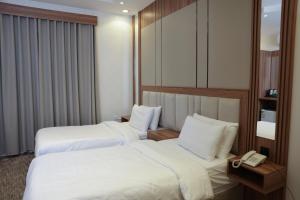 Postel nebo postele na pokoji v ubytování Buyot Malath Serviced Apartment - شقق بيوت ملاذ للشقق المخدومة