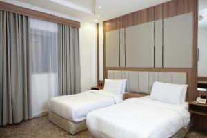 Postel nebo postele na pokoji v ubytování Buyot Malath Serviced Apartment - شقق بيوت ملاذ للشقق المخدومة