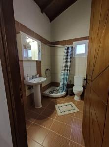 a small bathroom with a sink and a toilet at Bella Casa in Petrití +19 photos
