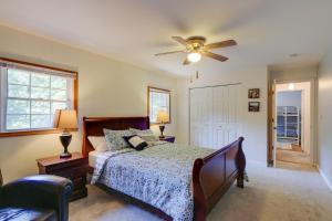 a bedroom with a bed and a ceiling fan at Harpers Ferry Cabin - Walk to Private Lake! in Harpers Ferry