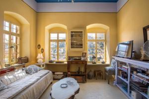 a living room with a couch and a table at kalosymi house, traditionelles haus mit hafenblick in Symi