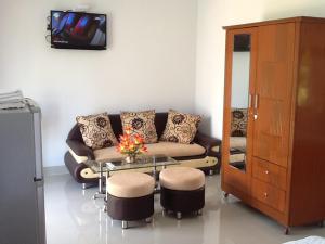 a living room with a couch and a table at Areca Resort in Mui Ne