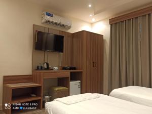 Postel nebo postele na pokoji v ubytování Buyot Malath Serviced Apartment - شقق بيوت ملاذ للشقق المخدومة
