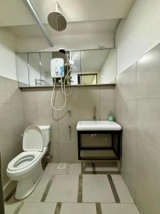 a bathroom with a toilet and a sink and a mirror at PCB The Seven Gardens Resort & Spa in Kota Bharu +42 photos