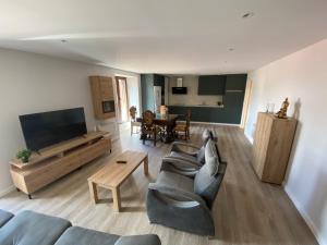 a living room with a couch and a tv at Amama Etxea in Arróniz