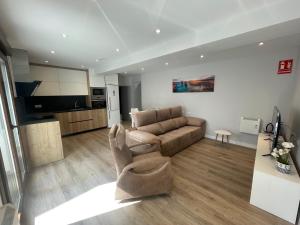 a living room with a couch and a kitchen at Amama Etxea in Arróniz