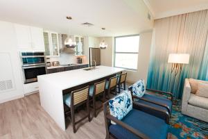 a kitchen and living room with a counter and chairs at Holiday Inn Club Vacations Myrtle Beach Oceanfront in Myrtle Beach