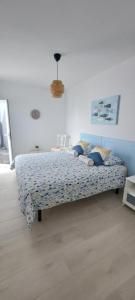 a bedroom with a bed with blue pillows on it at Punta Panoramic - Punta Mujeres in Punta Mujeres