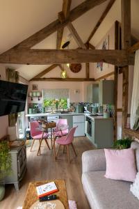 a living room with a couch and a kitchen at Field View Cottage hottub, dog friendly great view in Hereford