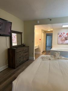 a bedroom with a bed with a dresser and a mirror at River Place Condos 609 1BD, 2 Bath in Pigeon Forge +15 photos