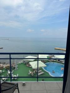 a view of a pool and the ocean from a balcony at Maristella Marine Residense Hotel Apartment in Odesa +44 photos