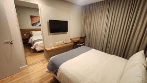 Postel nebo postele na pokoji v ubytování Elegance Flat no Serra Class + 43 fotografií