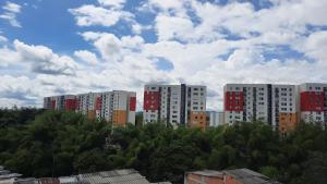 a group of tall buildings in a city with trees at Apartamento en un 4to piso cerca al coliseo en Armenia in Armenia