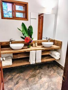 a bathroom with two sinks and a mirror at Private Lodge Sierra Nevada de Santa Marta in Santa Marta