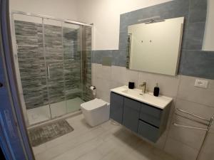 a bathroom with a shower and a sink and a toilet at Affitti brevi TAORMINA in Realmonte