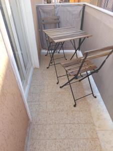 a table and a bench on a balcony at Affitti brevi TAORMINA in Realmonte