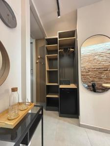 a kitchen with a table and a mirror at City room Zagreb in Zagreb