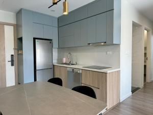 a kitchen with a table and chairs in a room at Kim Chi House - Imperia Smart City - 1 BR 55m2 in Hanoi