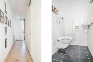 a bathroom with a toilet and a sink at Modern appartement met gratis fietsen in Breda