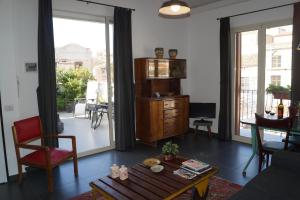 a living room with a red chair and a table at Guascone Apartments in Palermo