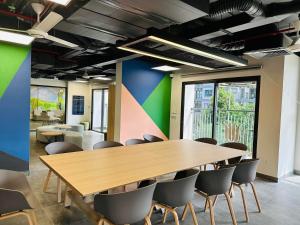 a conference room with a wooden table and chairs at Kim Chi House - Imperia Smart City - 1 BR 55m2 in Hanoi