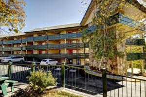 an apartment building with cars parked in front of it at Laurel Point Resort in Gatlinburg