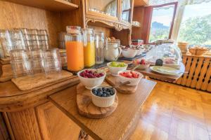 a kitchen with bowls of fruit on a wooden table at Falkenstein-Hütten in Bad Schandau +18 photos