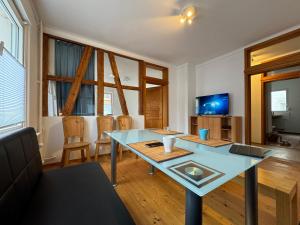 a living room with a glass table and chairs at 90qm 4-Zimmer-Wohnung - Apartment Friedrichstraße in Vaihingen an der Enz
